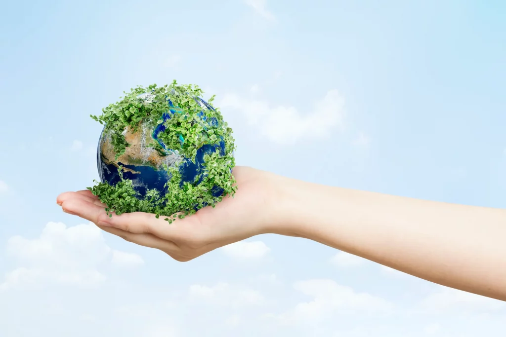 A hand holding a globe that is green. This is to show the environmental policies that Blenford Construction has adopted to help the planet in our little way.
