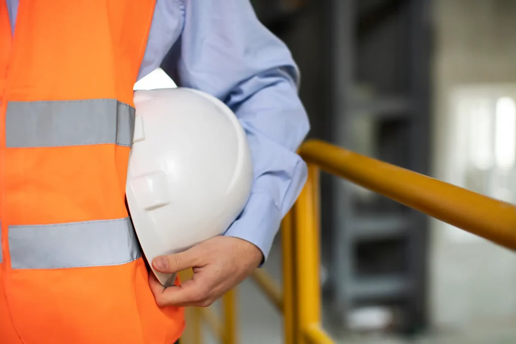 A person in a high visibility vest with a hard-hat to show the Health and Safety policies that Blenford Construction has adopted to provide our services in a safe manner.
